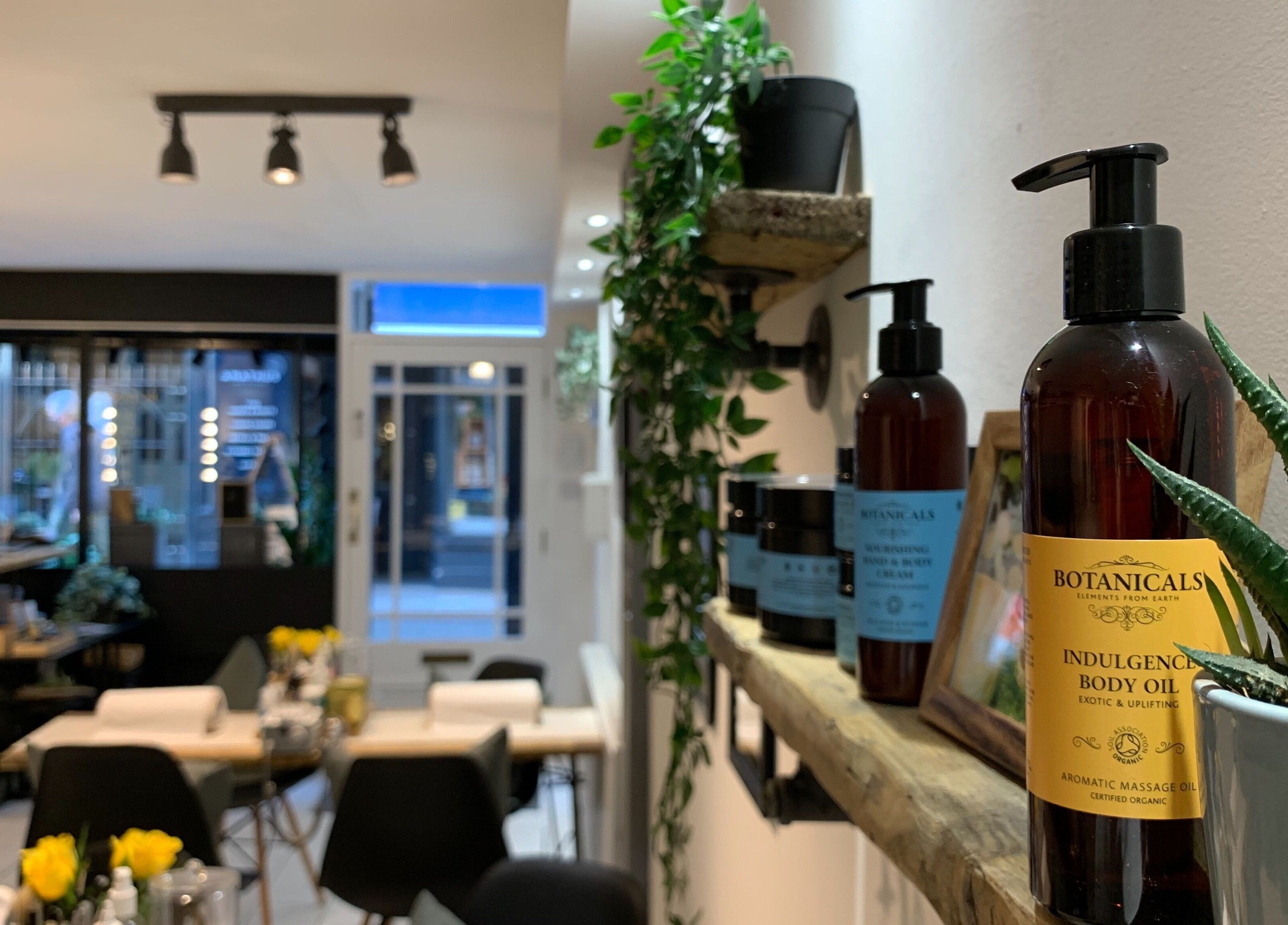 Serene interior of La Déesse Beauty Loft in Bath, England, GB featuring wellness products and greenery.