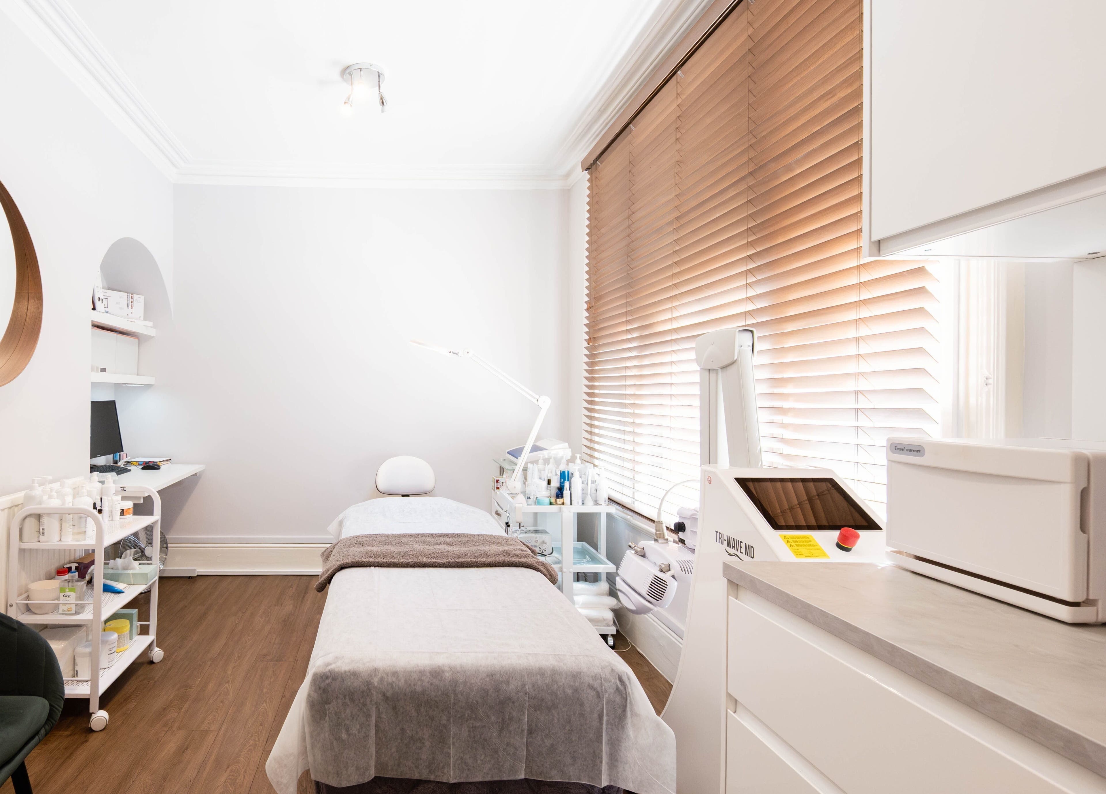 Modern treatment room at Meta Beauty in London, England, GB. Minimalist decor with advanced skincare equipment.