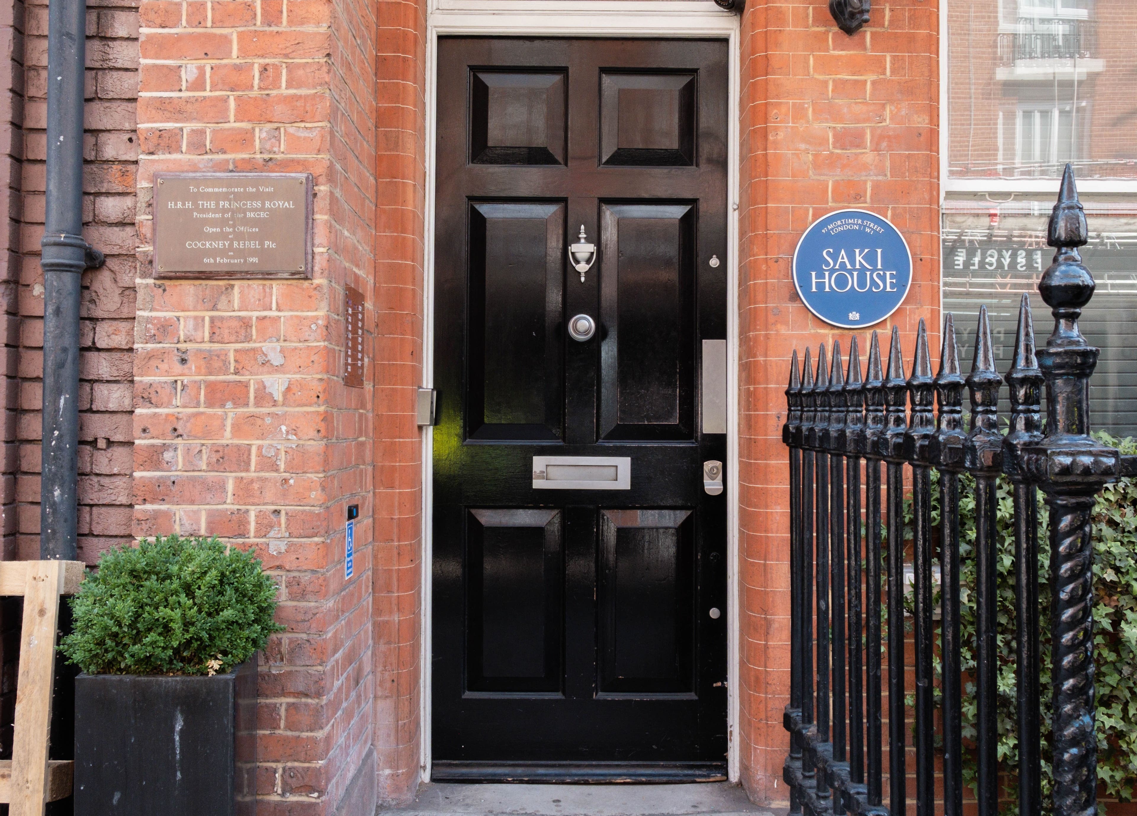 Charming entrance of Meta Beauty at Saki House, London, England, GB with black door and brick facade.