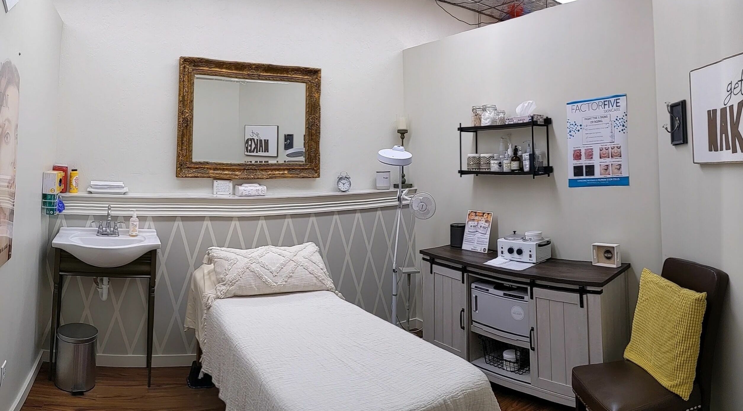 Elegant spa room at His & Hers Bare Beauty in Sarasota, FL, US. Features a treatment bed, mirror, and stylish decor.