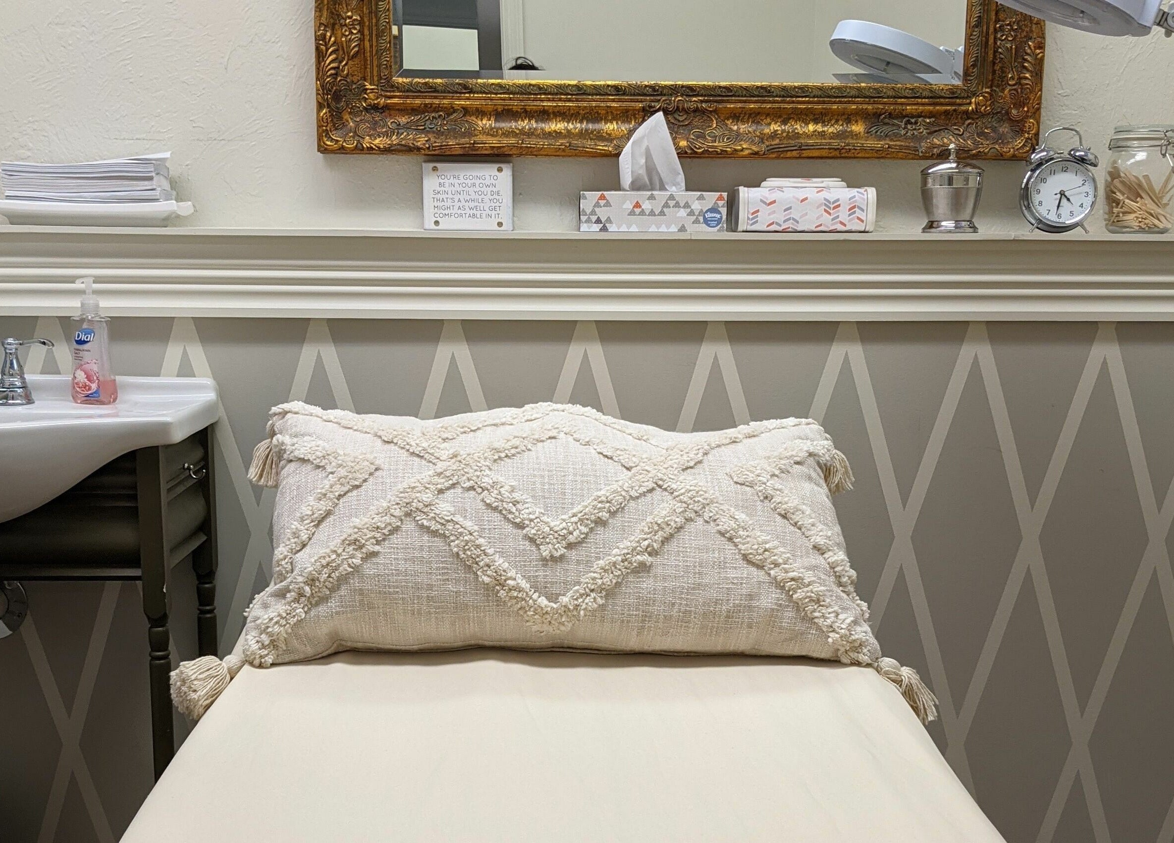 Relaxing treatment room at His & Hers Bare Beauty, Sarasota, FL, US, with plush bedding and elegant decor.