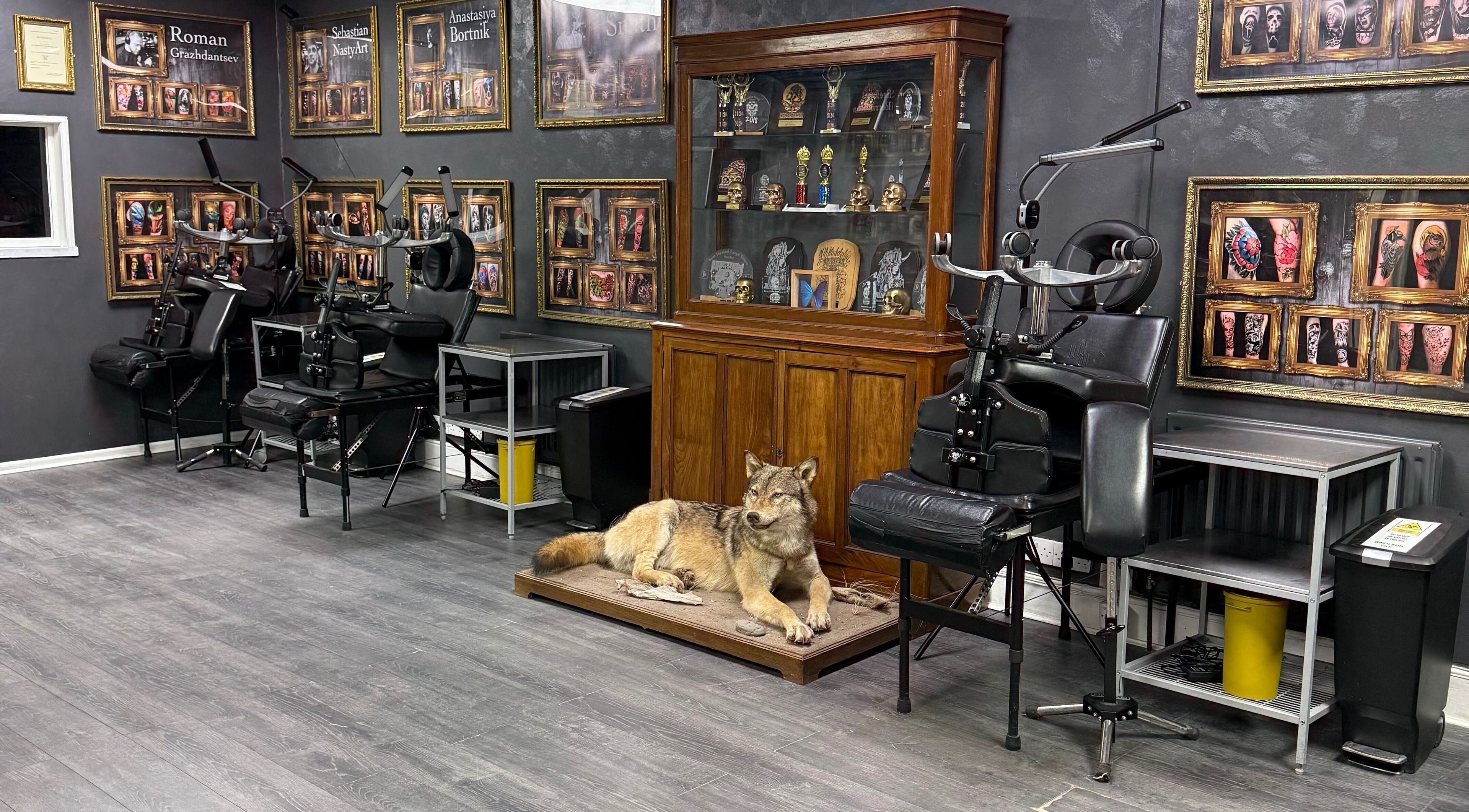 Interior of Holy Grail Tattoo Studio, Clitheroe, England, GB, featuring tattoo chairs and artistic decor.