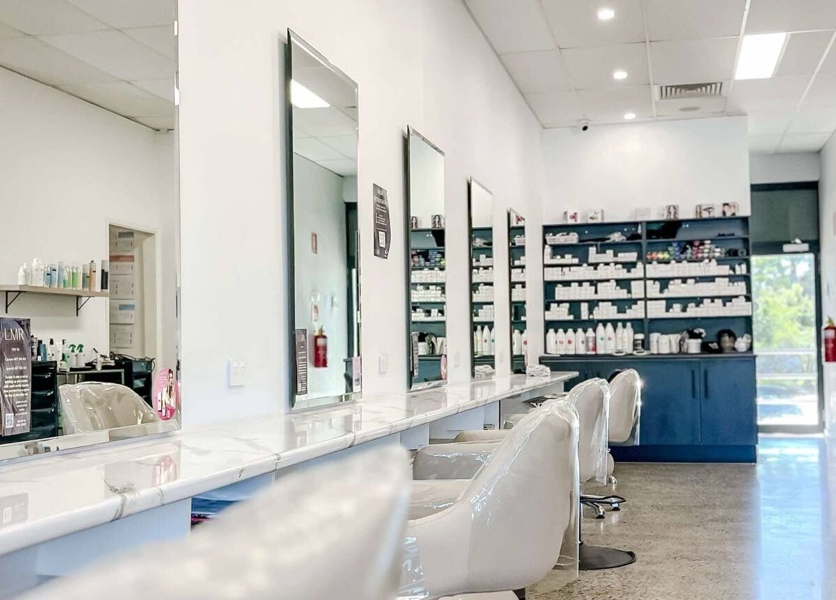Spacious mirrors line Lily Me Red - CARRARA salon in Carrara, Queensland, AU showcasing a modern, clean design.