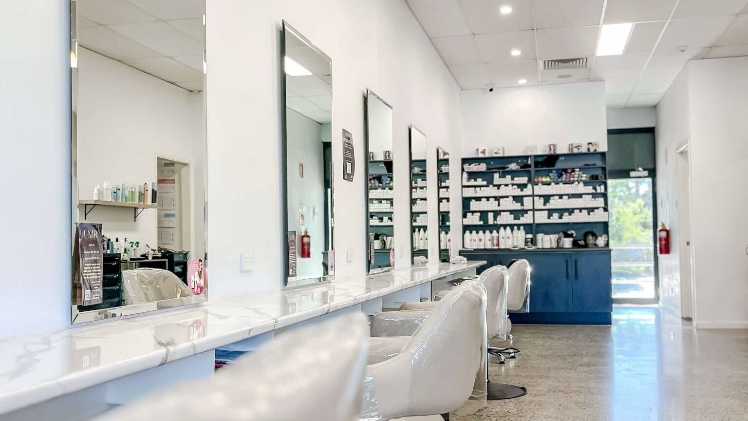 Spacious mirrors line Lily Me Red - CARRARA salon in Carrara, Queensland, AU showcasing a modern, clean design.