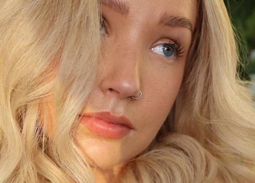 Elegant woman with soft curls and radiant skin at Lily Me Red - CARRARA, Carrara, Queensland, AU.