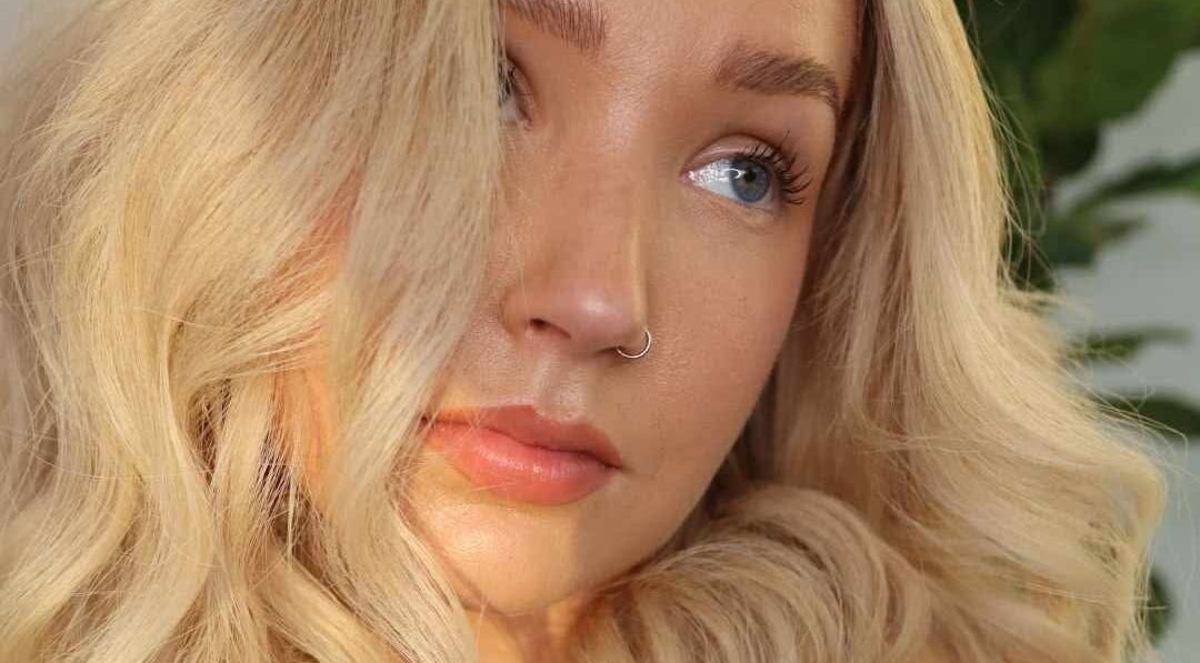Elegant woman with soft curls and radiant skin at Lily Me Red - CARRARA, Carrara, Queensland, AU.
