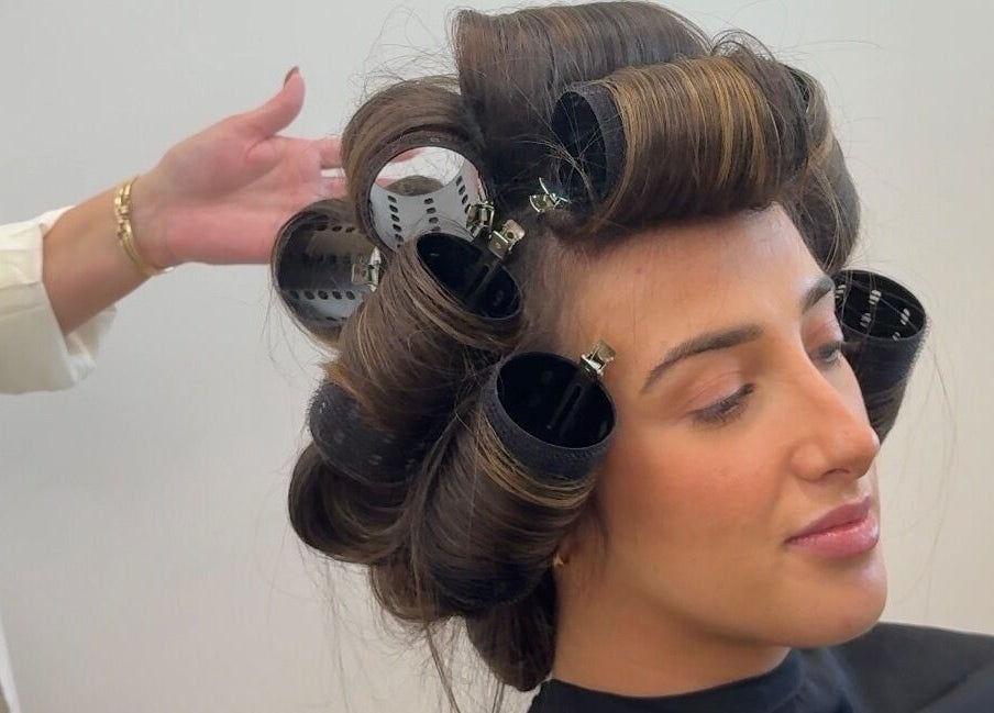 Client at Lily Me Red - CARRARA getting styled with rollers in Carrara, Queensland, AU.