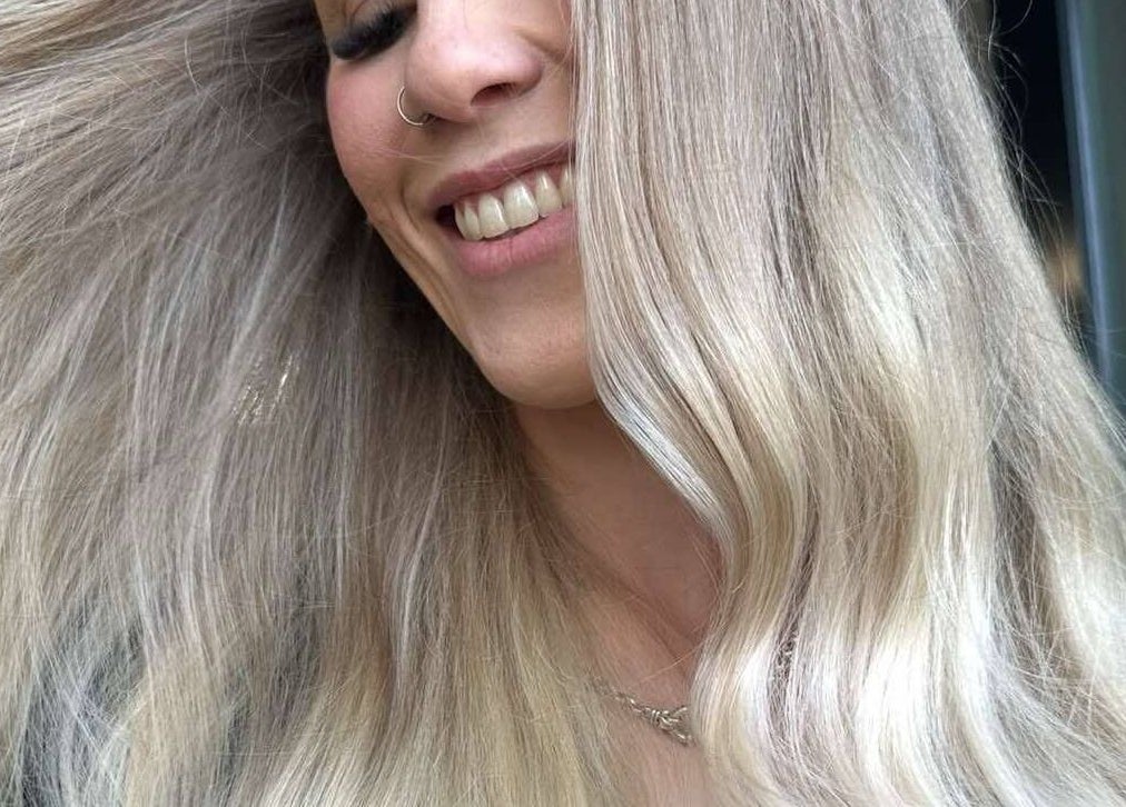 Woman showcasing stunning hair transformation at Lily Me Red - CARRARA in Carrara, Queensland, AU.