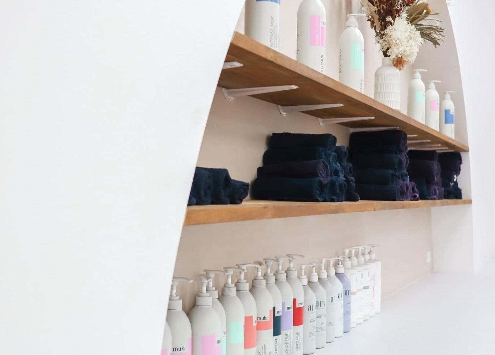 Organized shelves with products and towels at Lily Me Red IPSWICH, North Ipswich, Queensland, AU.