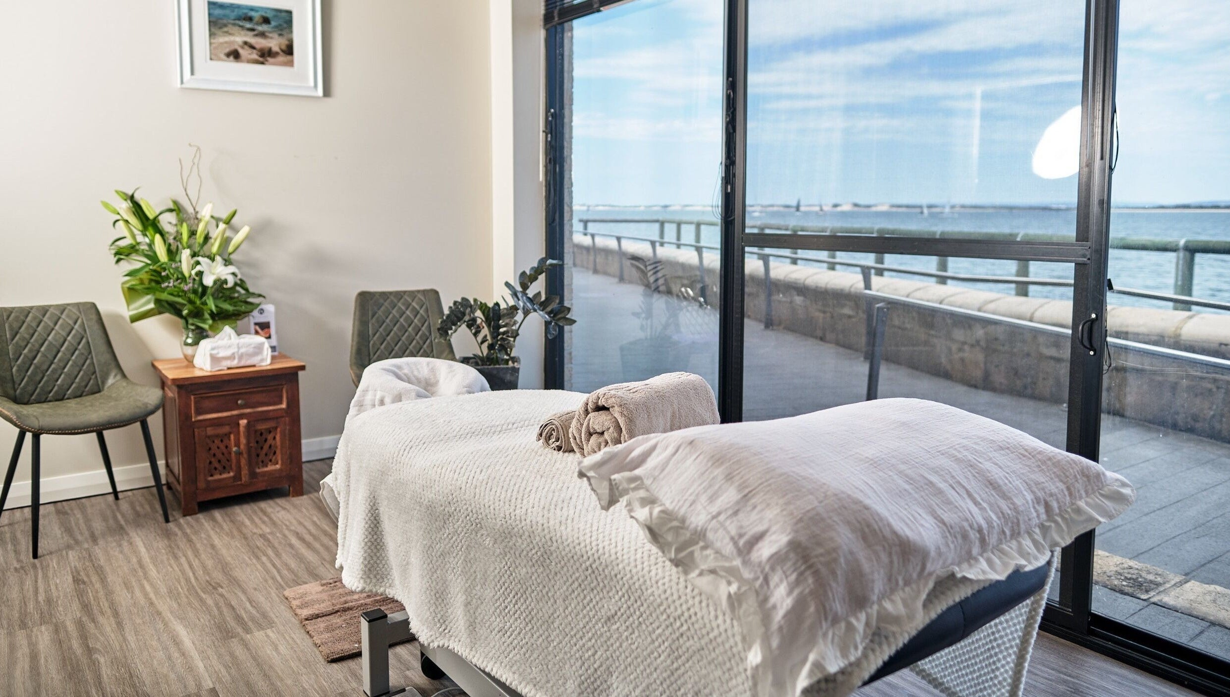 Tranquil massage room at My Balance Massage, Withers, Western Australia, AU, with ocean view through large windows.