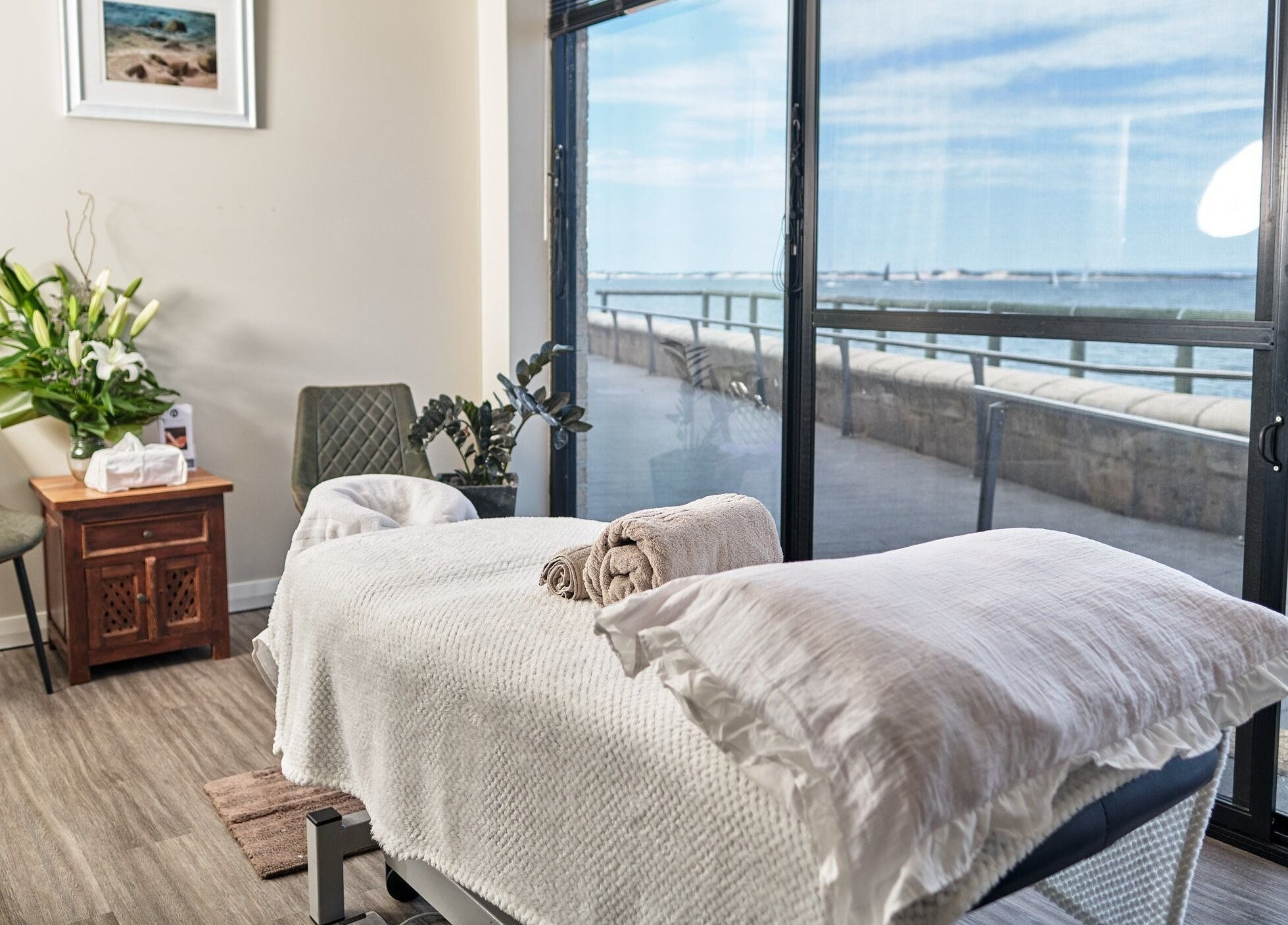 Tranquil massage room at My Balance Massage, Withers, Western Australia, AU, with ocean view through large windows.