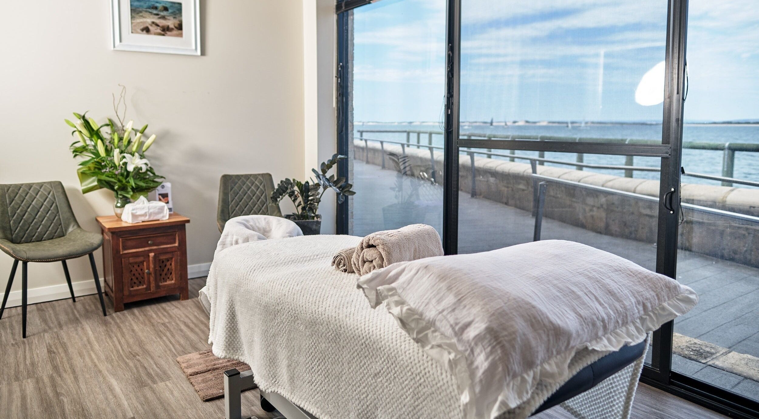 Tranquil massage room at My Balance Massage, Withers, Western Australia, AU, with ocean view through large windows.