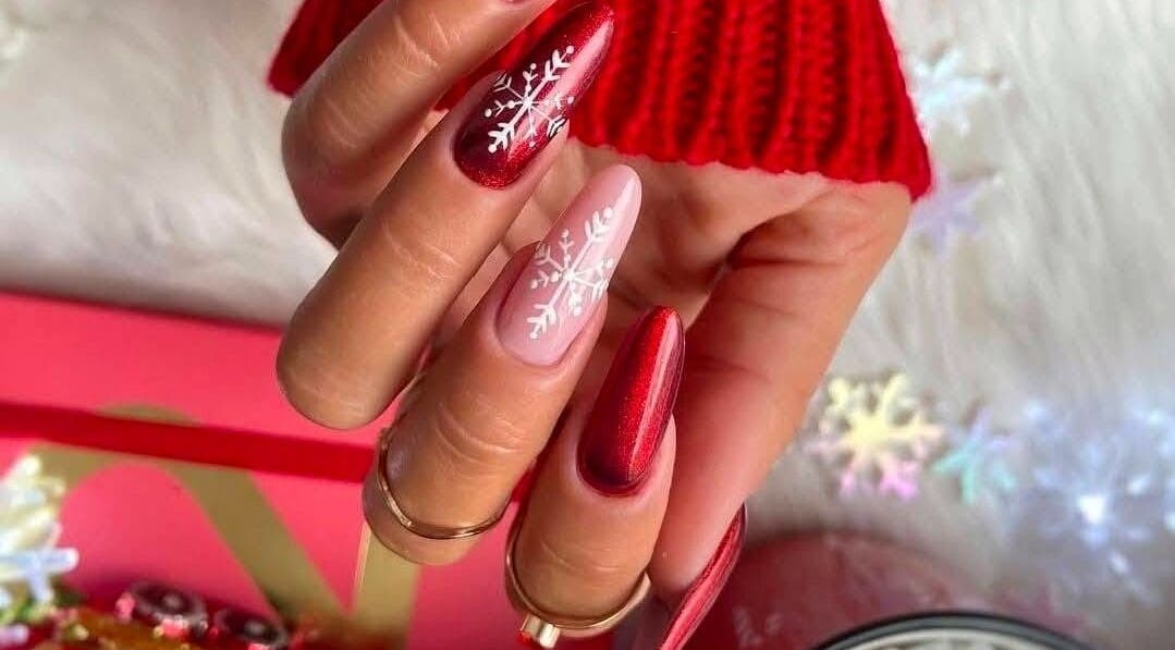 Elegant red and pink snowflake nail art at Serena Nails and Spa in Burlington, Massachusetts, US.