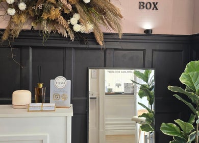 Stylish interior of Dionne The Dressing Up Box in Bolton, England, showcasing elegant decor and floral arrangements.