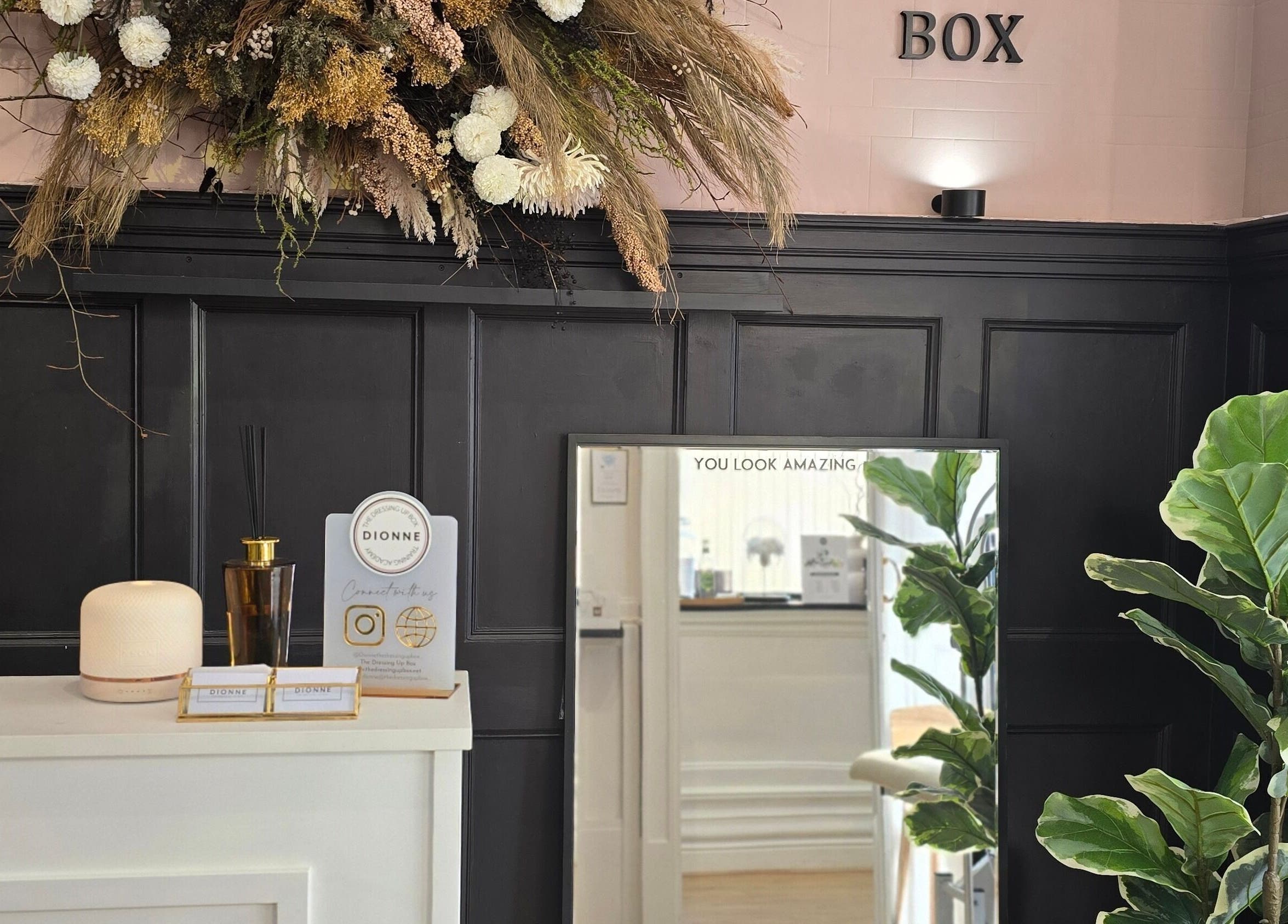 Stylish interior of Dionne The Dressing Up Box in Bolton, England, showcasing elegant decor and floral arrangements.