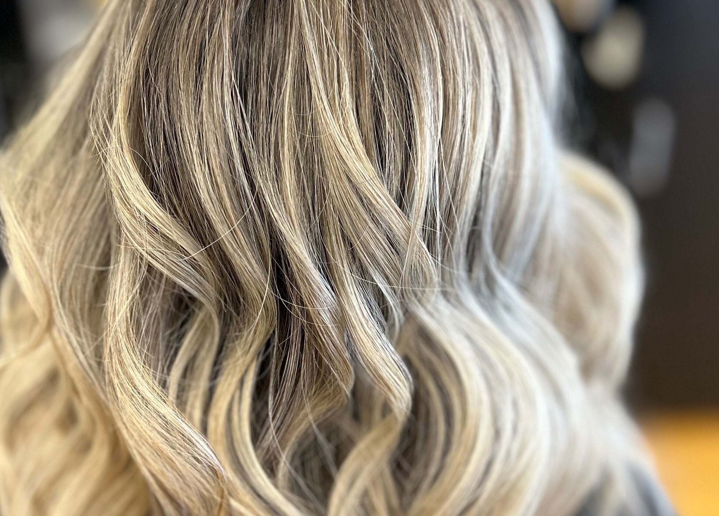 Stylish blonde wavy hair at The Craft Salon by Tara Lauren in New Smyrna Beach, Florida, US.