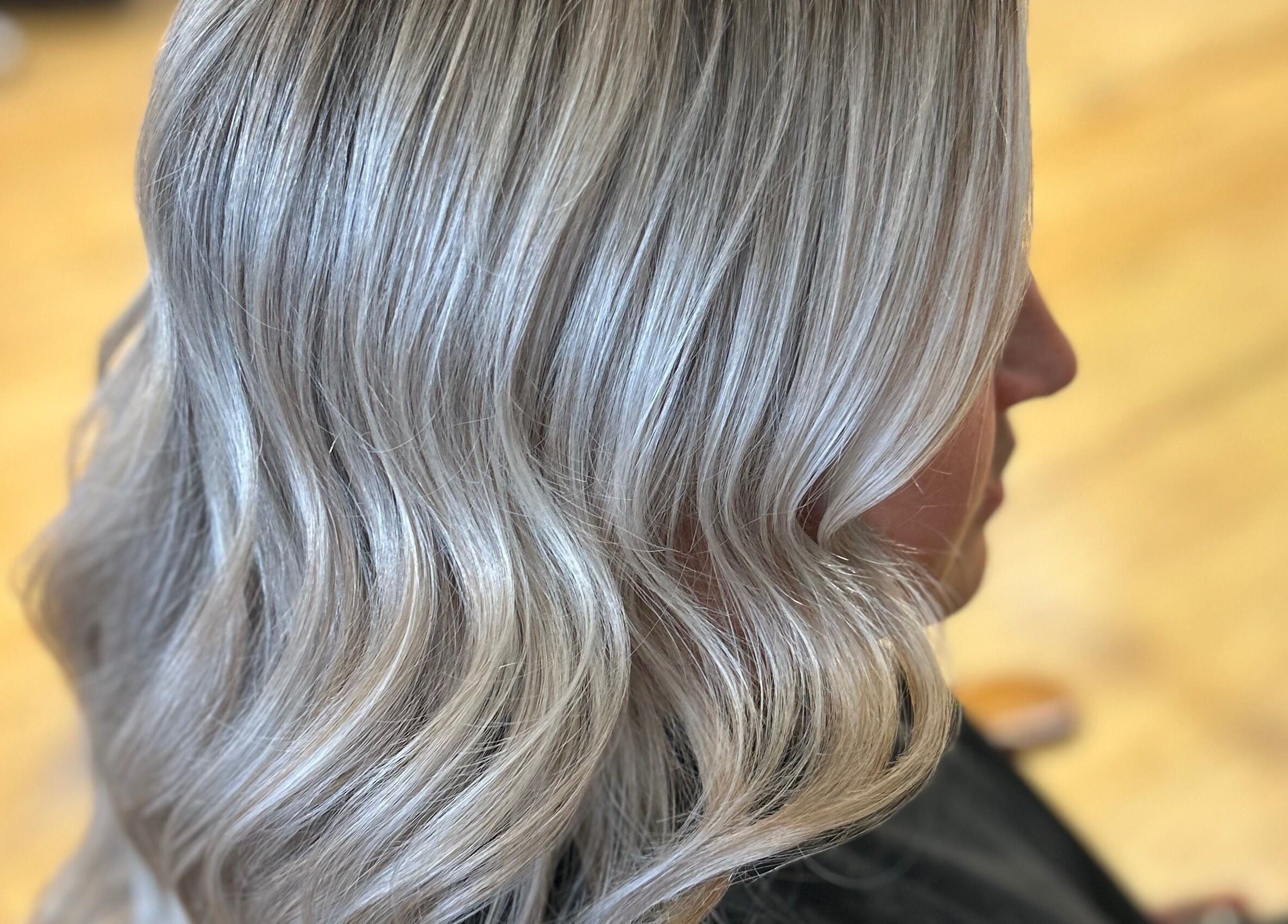 Elegant silver hair waves styled at The Craft Salon by Tara Lauren in New Smyrna Beach, Florida, US.