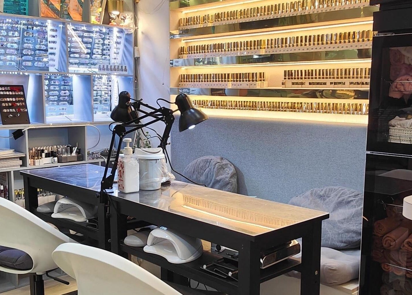 Inside Finger Bar and Studio, Singapore, showcasing stylish nail stations filled with vibrant nail polish displays.