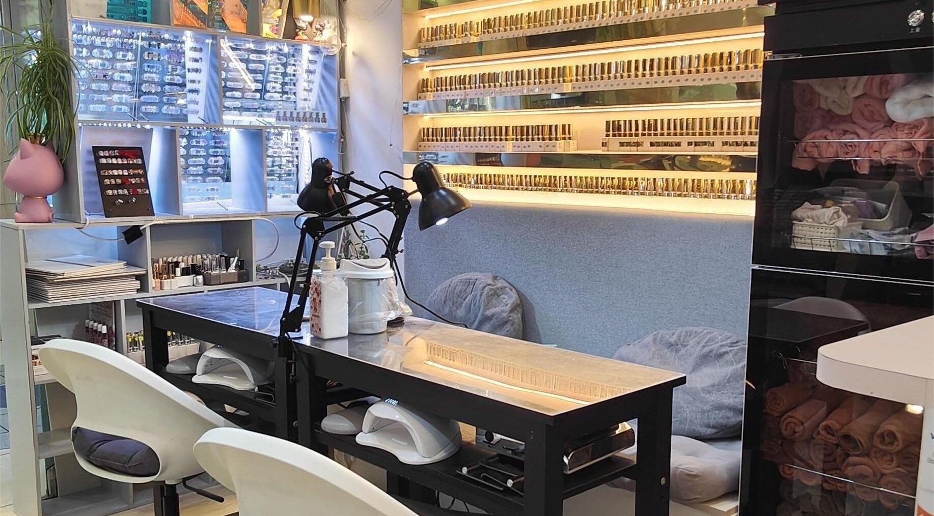 Inside Finger Bar and Studio, Singapore, showcasing stylish nail stations filled with vibrant nail polish displays.