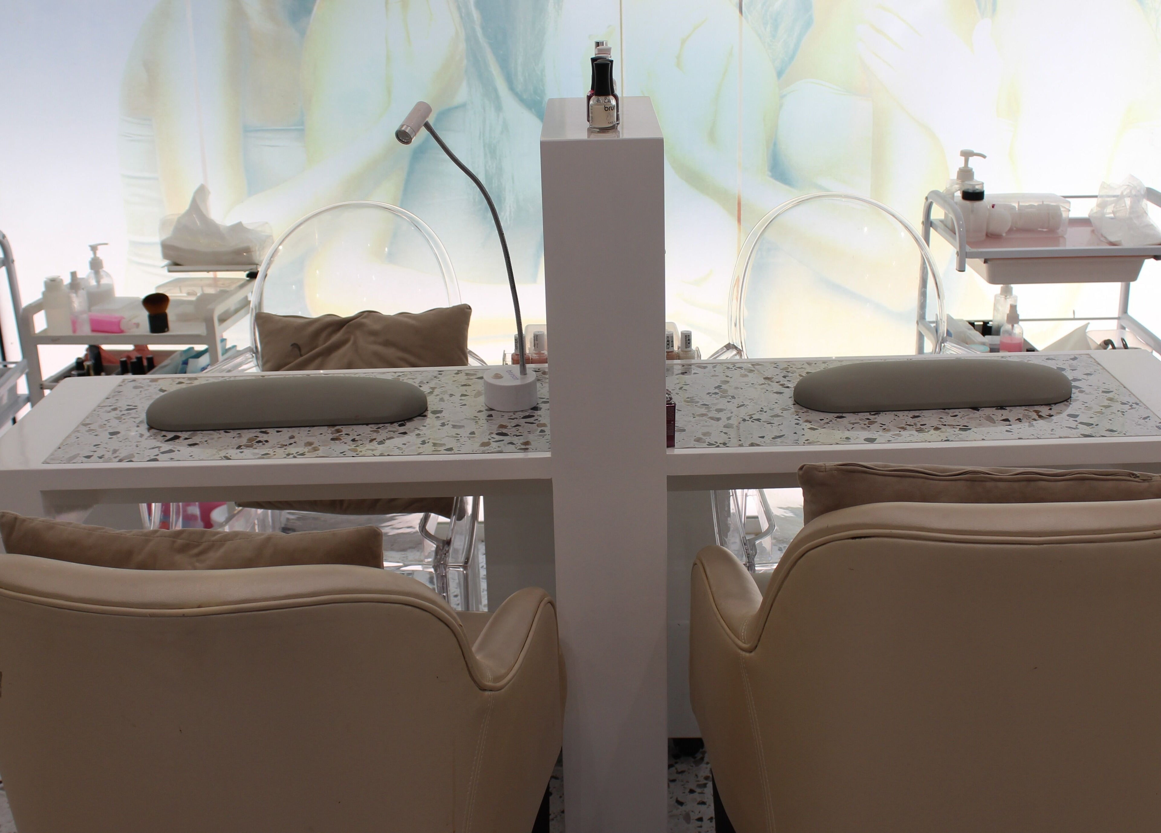 Seier Shades Salon manicure station in Dubai, Dubai, AE, featuring plush chairs and modern decor.