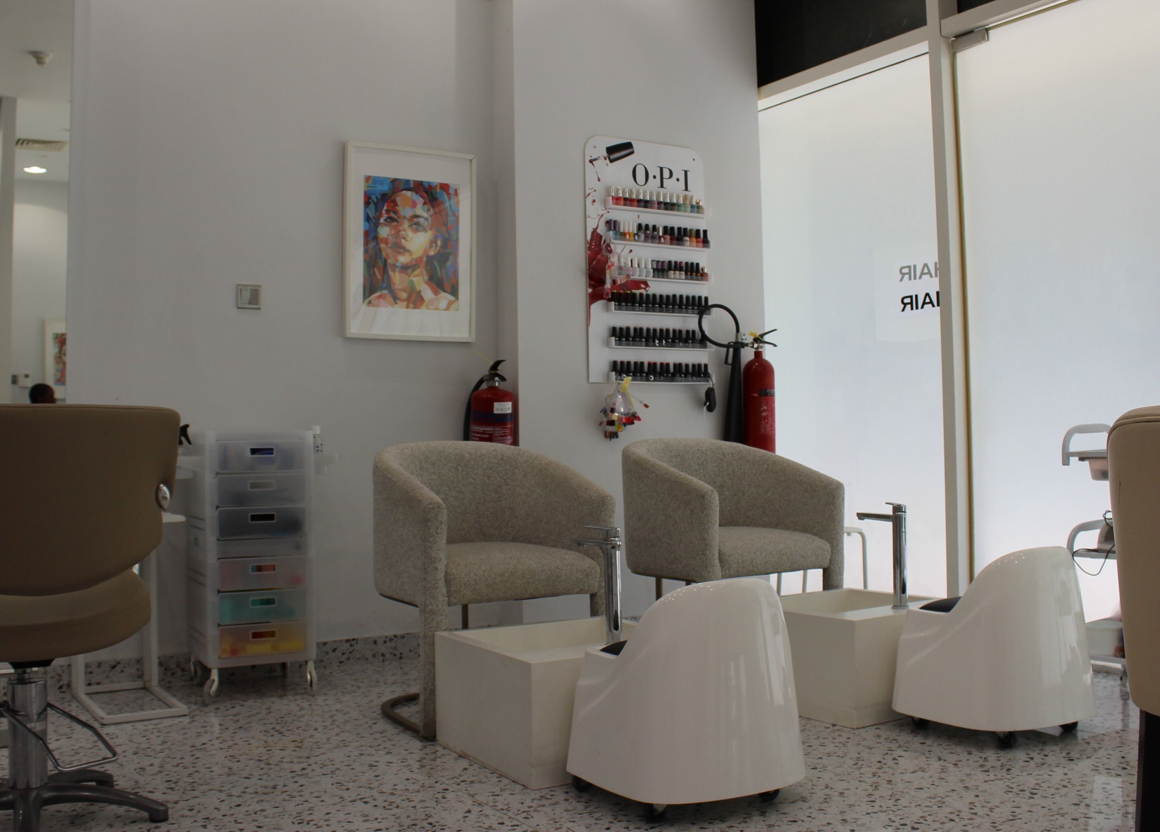 Cozy seating area in Seier Shades Salon, Dubai, Dubai, AE, showcasing modern decor and nail polish display.