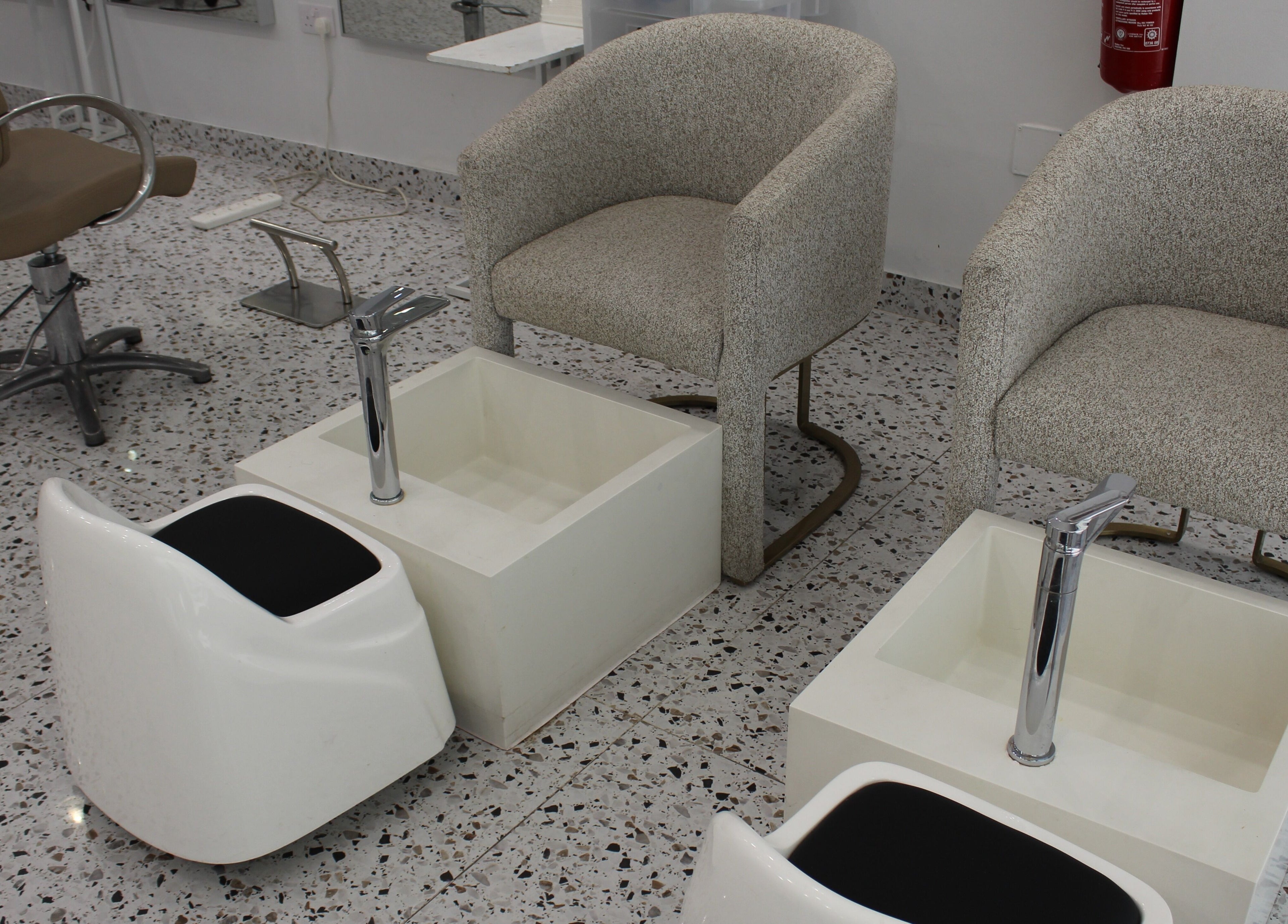 Pedicure stations with beige chairs at Seier Shades Salon, Dubai, Dubai, AE.