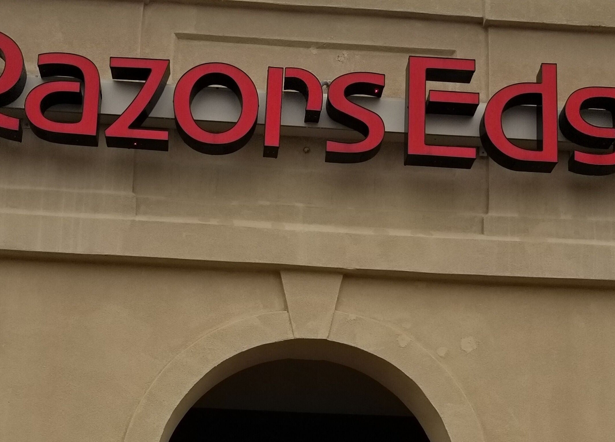 Signage of Razors Edge Hair Salon in Hattiesburg, Mississippi, US, displaying bold red letters.