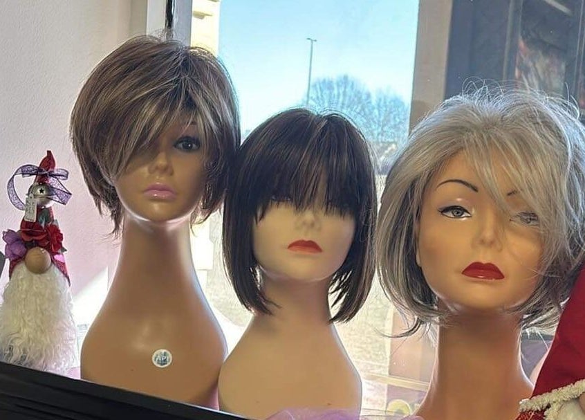 Display of modern wigs at Razors Edge Hair Salon in Hattiesburg, Mississippi, US showcasing chic hairstyle options.