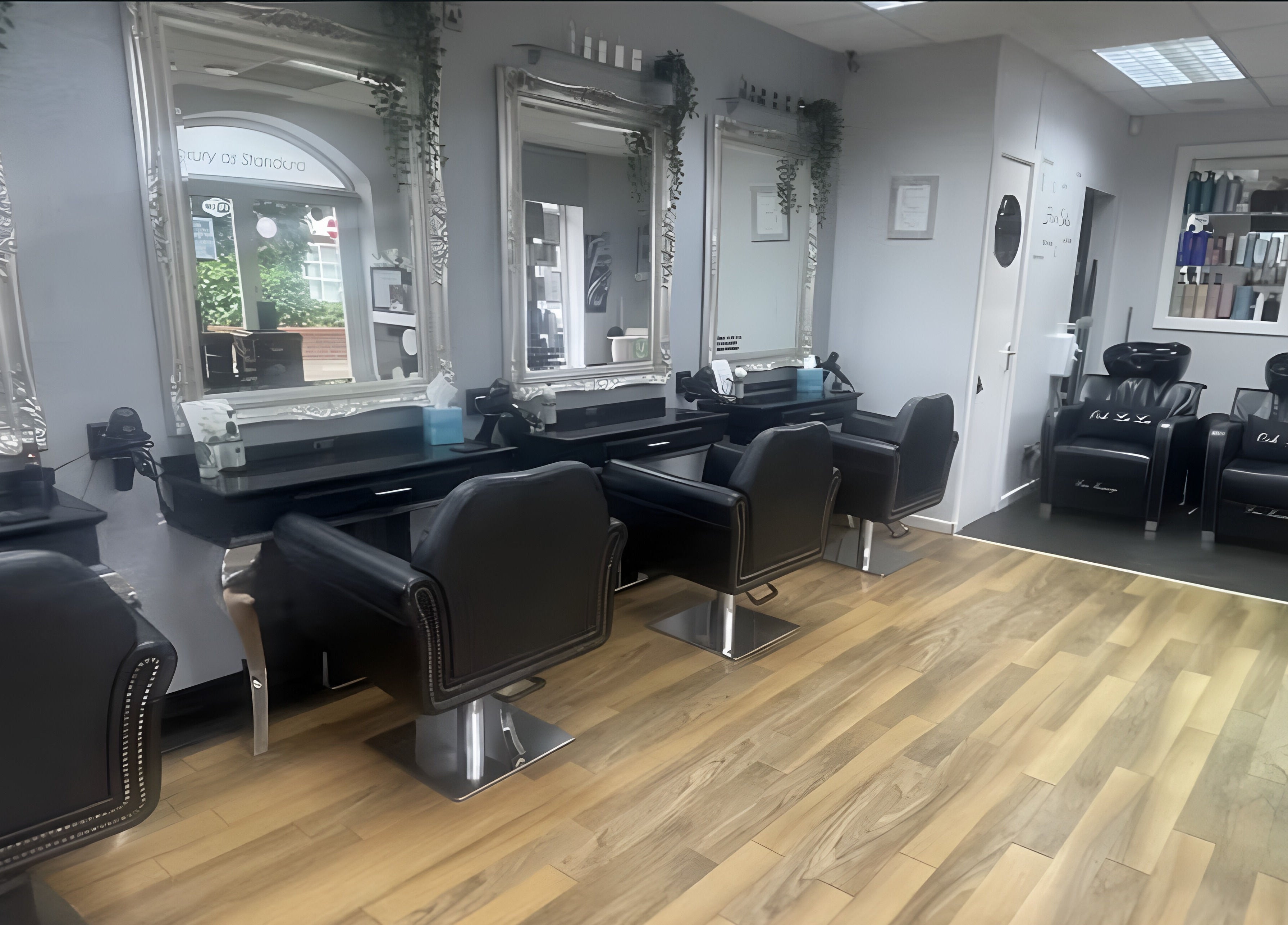 Interior of Hair By Ooh La La salon in Witham, England, GB, featuring elegant styling stations.