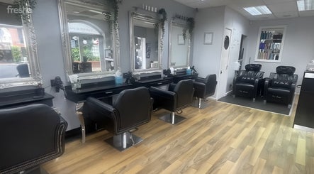Interior of Hair By Ooh La La salon in Witham, England, GB, featuring elegant styling stations.
