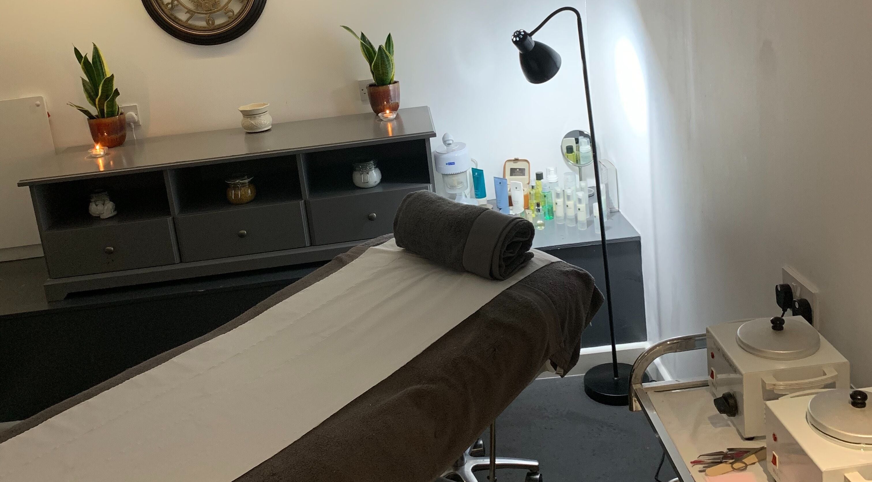 Relaxing treatment room at Kimoys Unisex Hair Salon, Gravesend, England, GB. Cozy ambiance with plush massage bed.