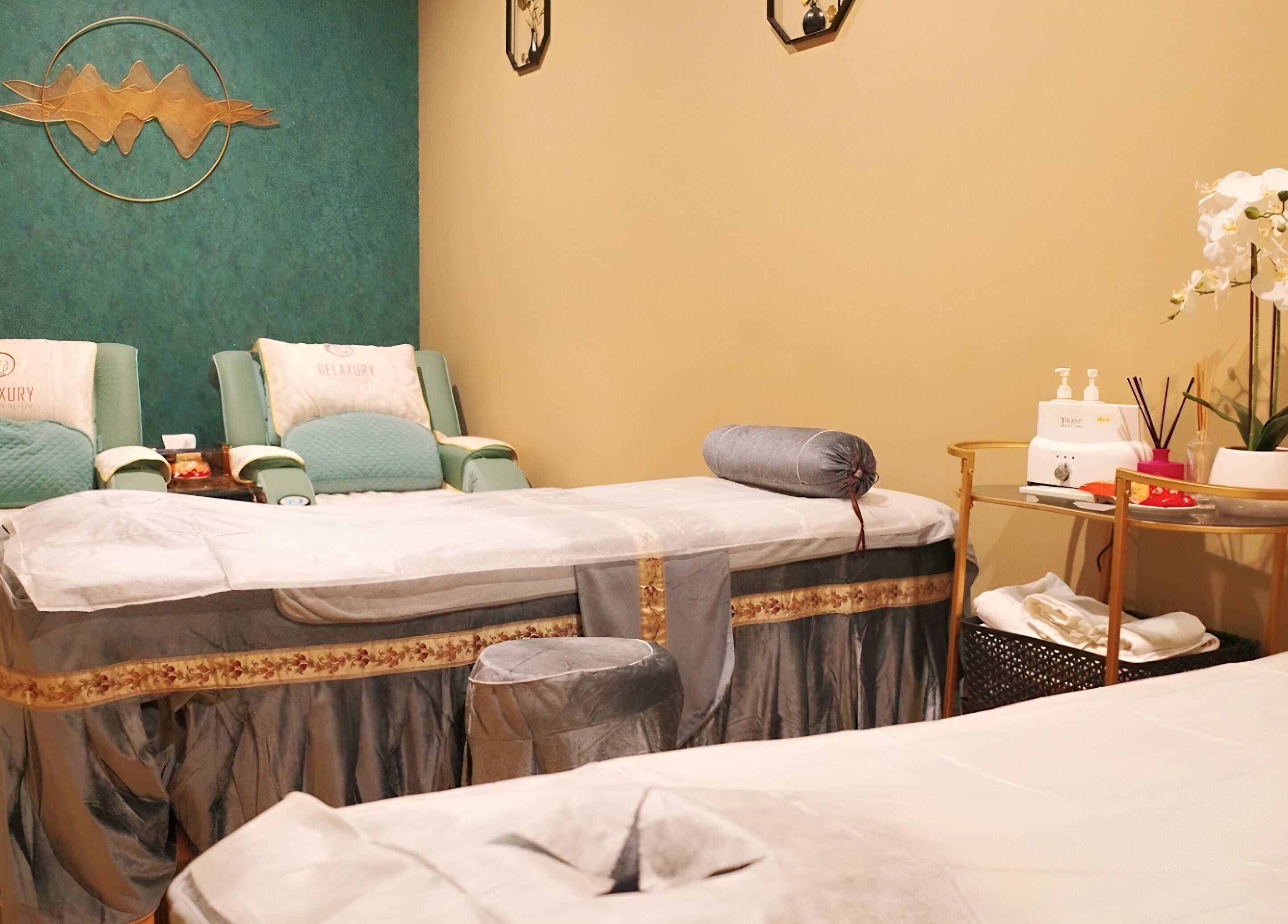 Elegant massage room at Relaxury in Auckland, NZ with plush beds and soothing decor for ultimate relaxation.
