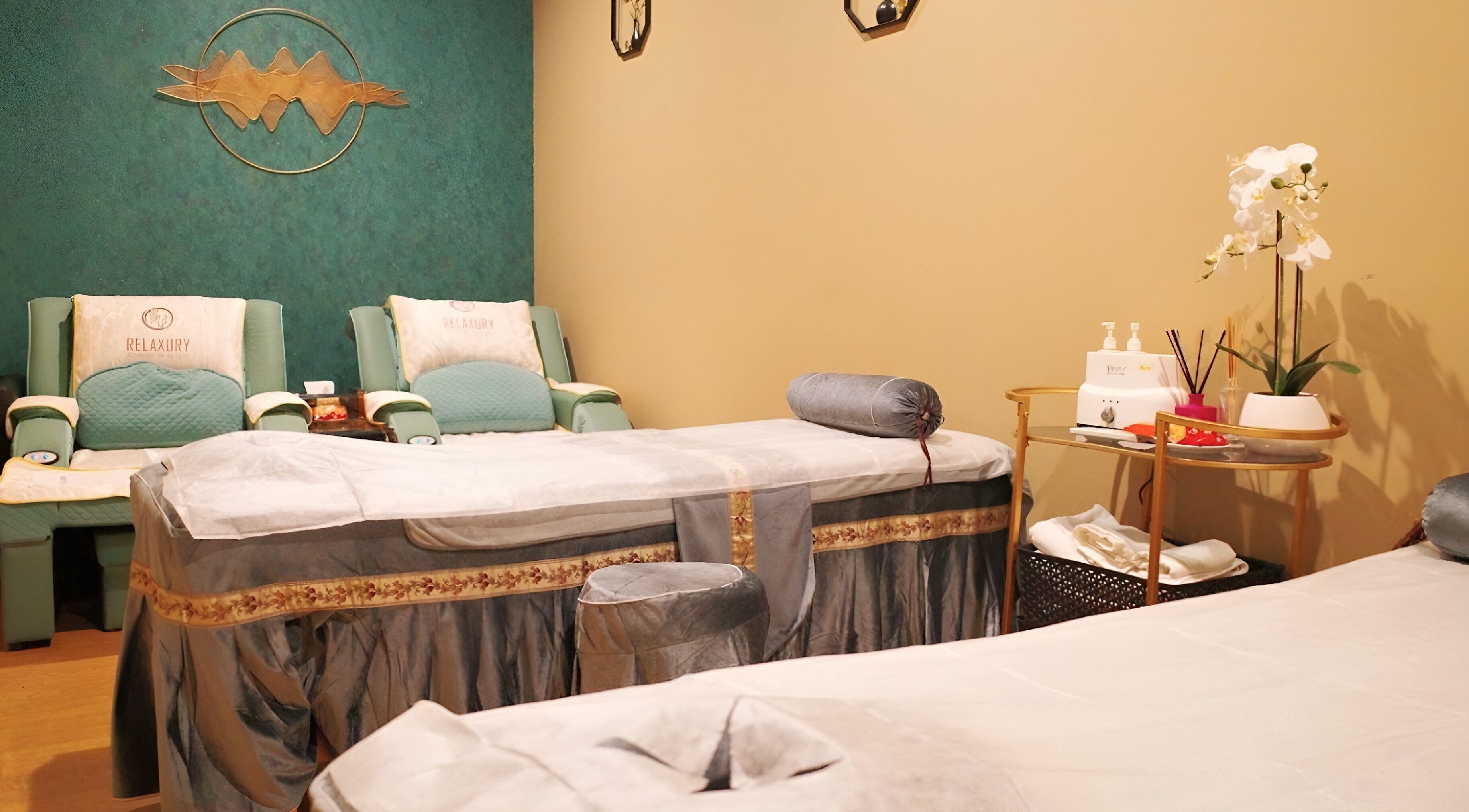 Elegant massage room at Relaxury in Auckland, NZ with plush beds and soothing decor for ultimate relaxation.
