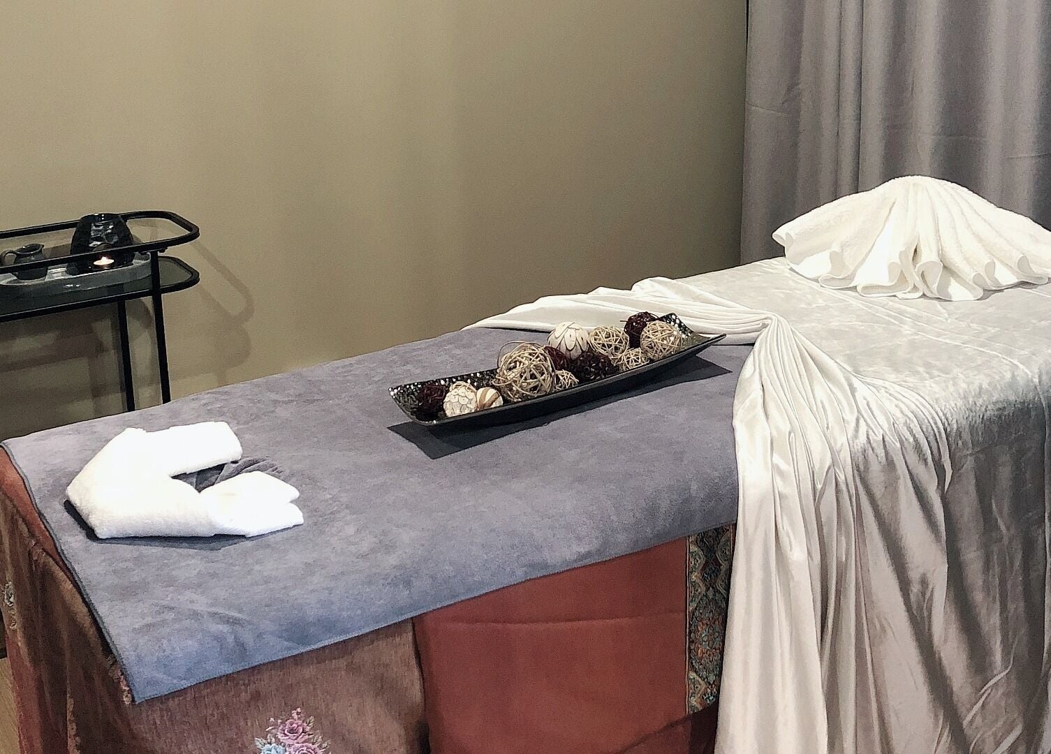 Relaxury massage room in Auckland, Auckland, NZ, featuring a plush massage table in a tranquil setting.