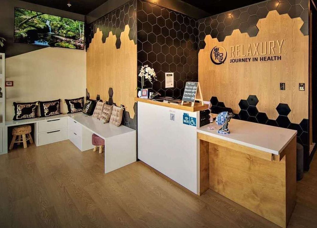 Relaxury reception area in Auckland, NZ exudes warmth with modern decor and comfy seating.