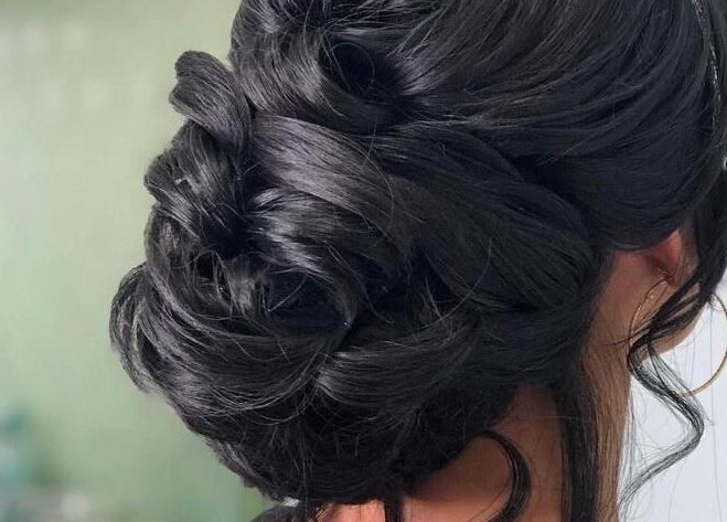 Sophisticated updo hairstyle at Beauty Hunters The Pearl, Doha, QA, showcasing intricate styling.