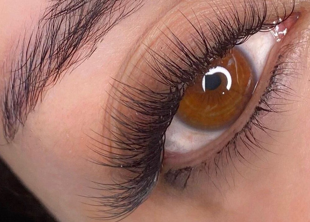 Close-up of eye with lashes styled at Beauty Hunters The Pearl, Doha, QA for an elegant look.