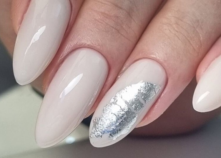 Elegant white nails with silver accents at Beauty Hunters The Pearl, Doha, QA, showcasing sophisticated nail art.