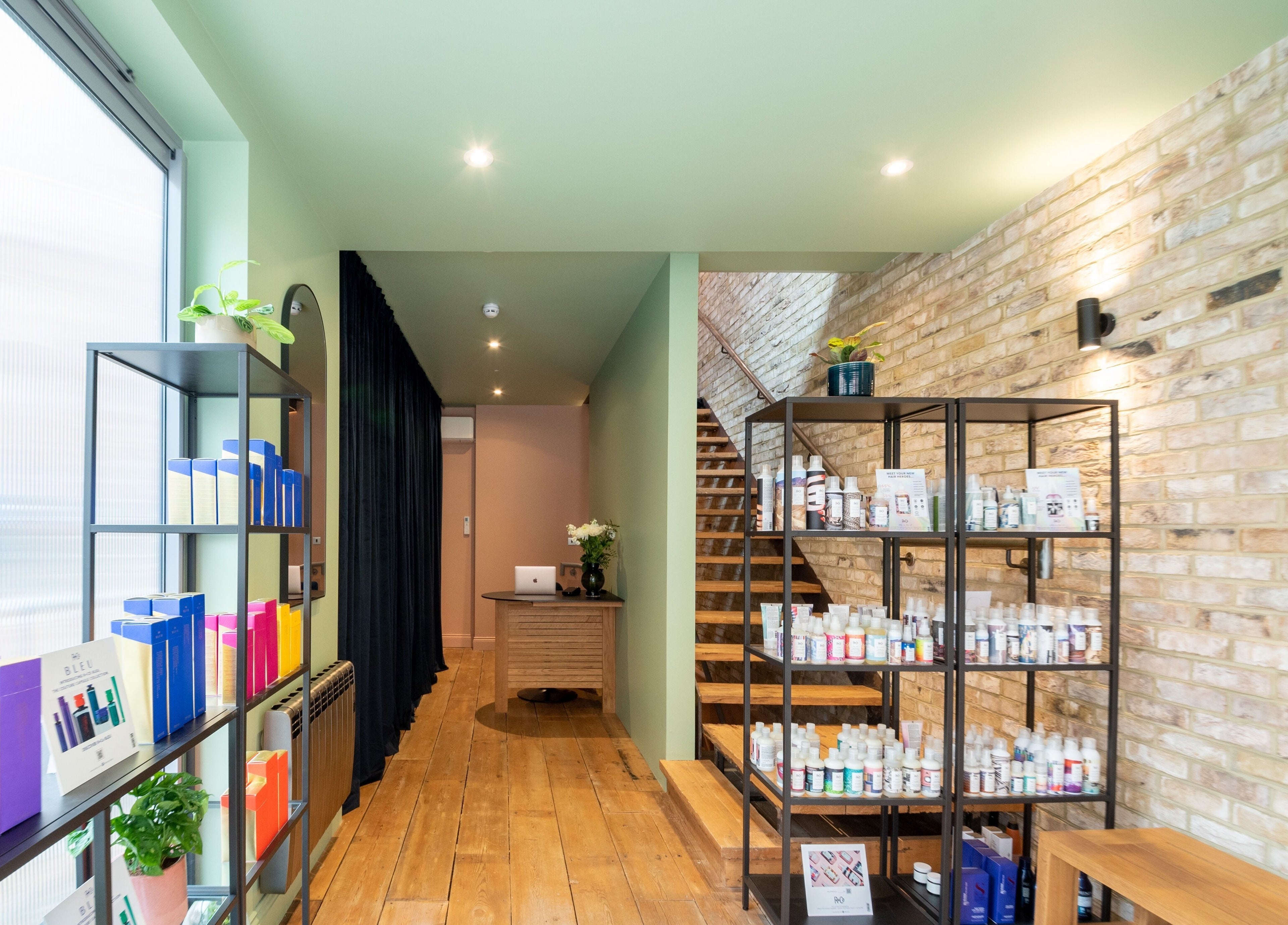 Modern product display and staircase in Bond, London, England, GB, showcasing beauty and wellness items.