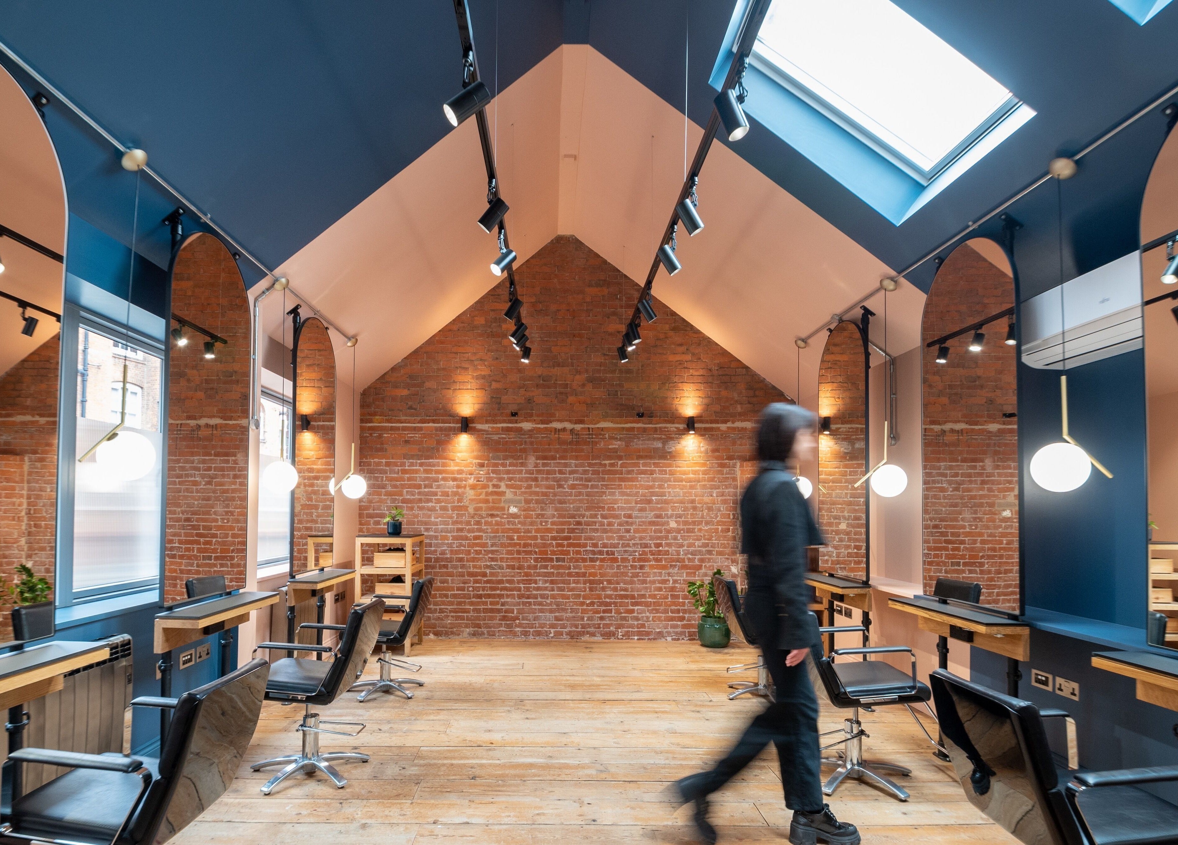 Modern salon interior with sleek styling stations at Bond, London, England, GB.