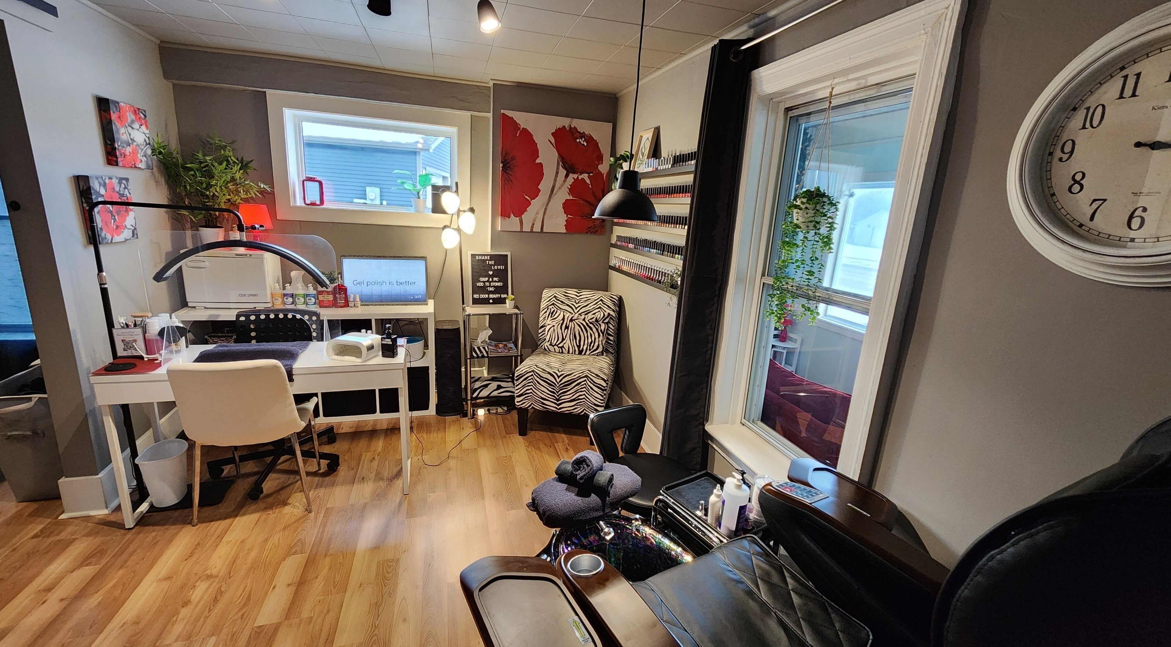 Cozy interior of Red Door Beauty Bar in Angus, Ontario, CA featuring nail station and elegant decor.