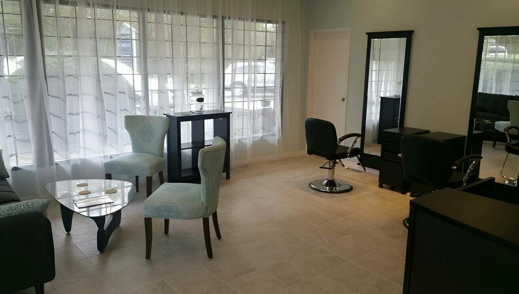Tranquil ambiance at Beauty Time Salon and Spa in Vancouver, British Columbia, CA, showcasing elegant chairs and mirrors.