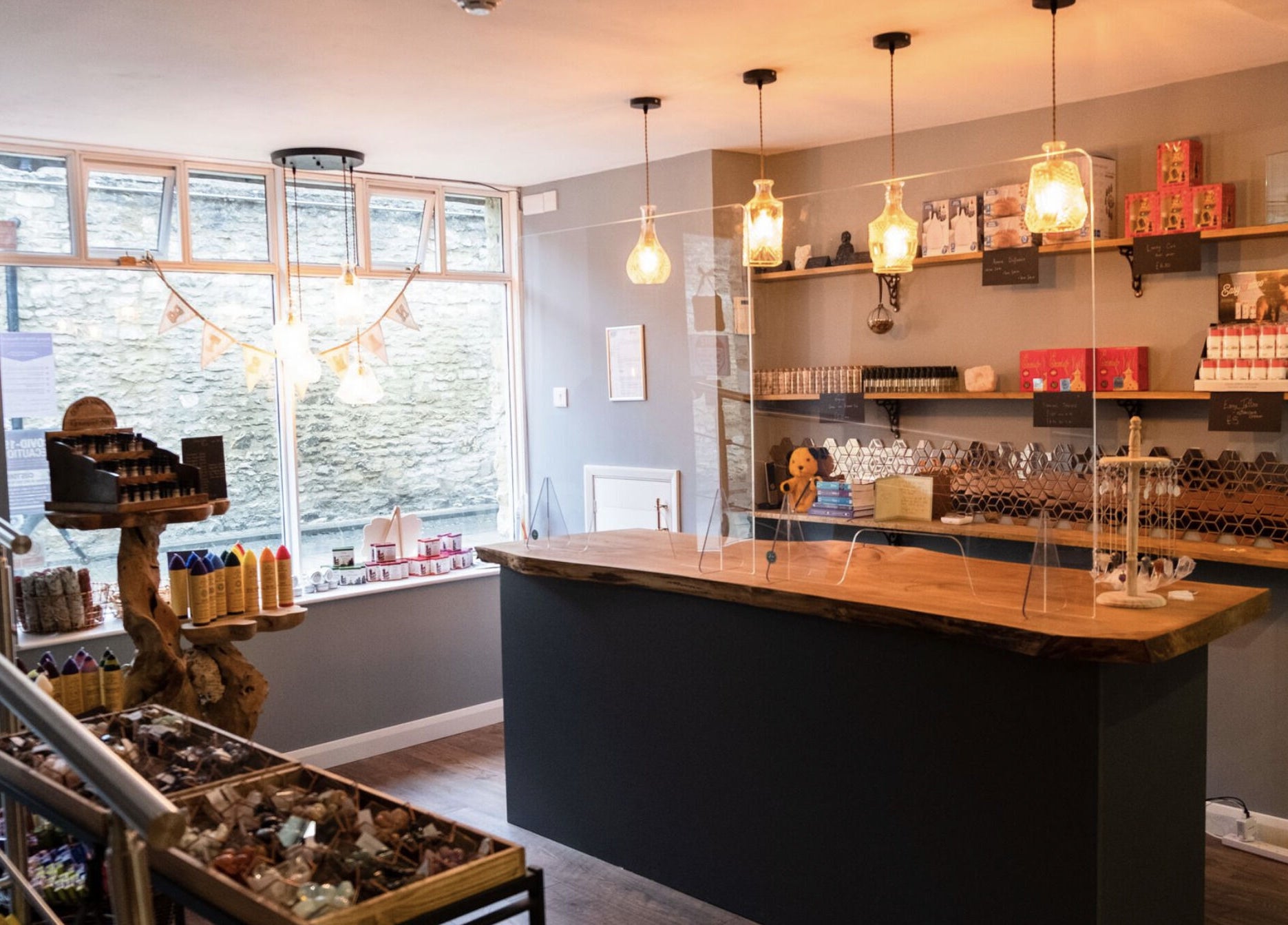 Warm, inviting reception at The Avalon Rooms, Witney, England showcasing organic products and rustic decor.