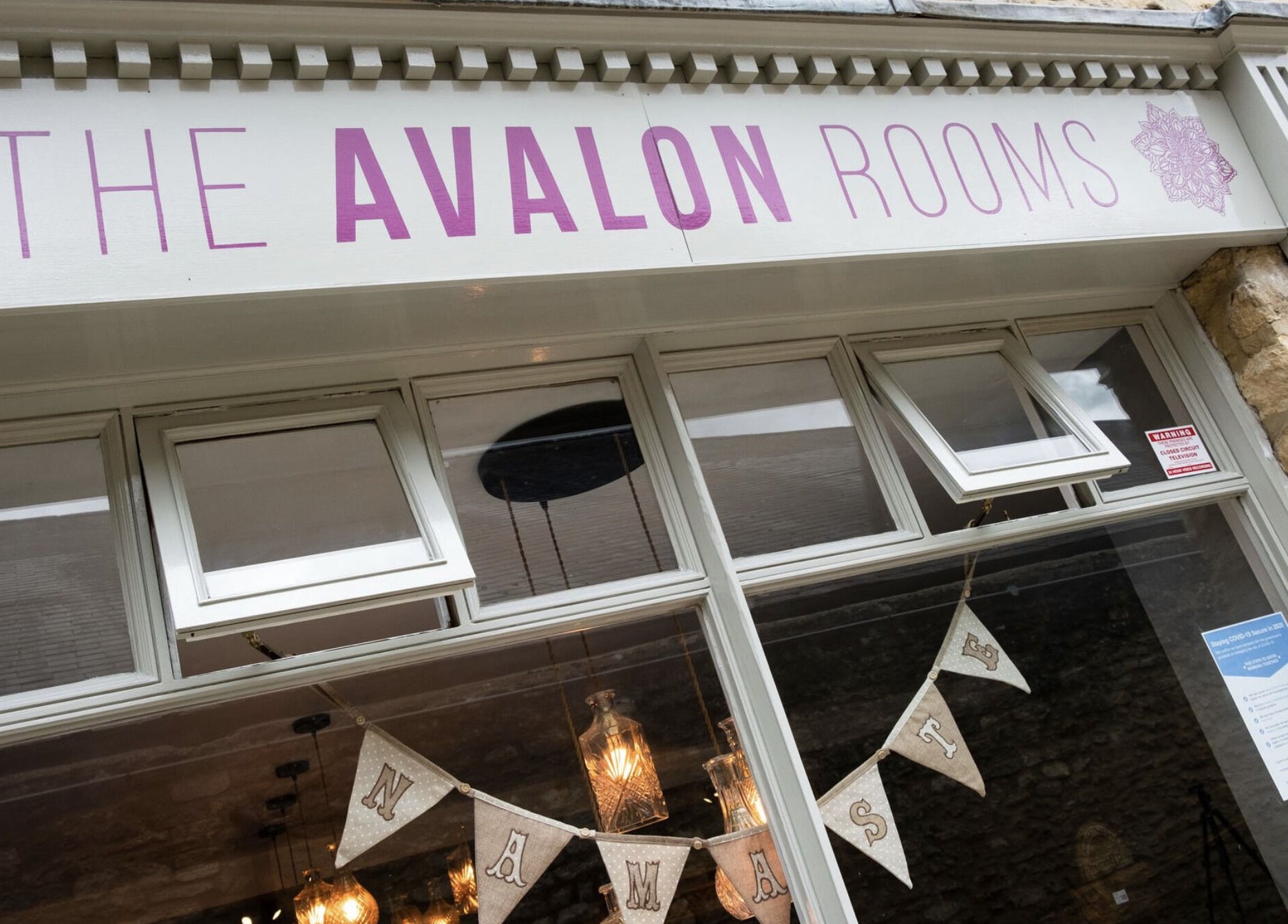 Entrance view of The Avalon Rooms in Witney, England, GB, featuring decorative signage and stone facade.