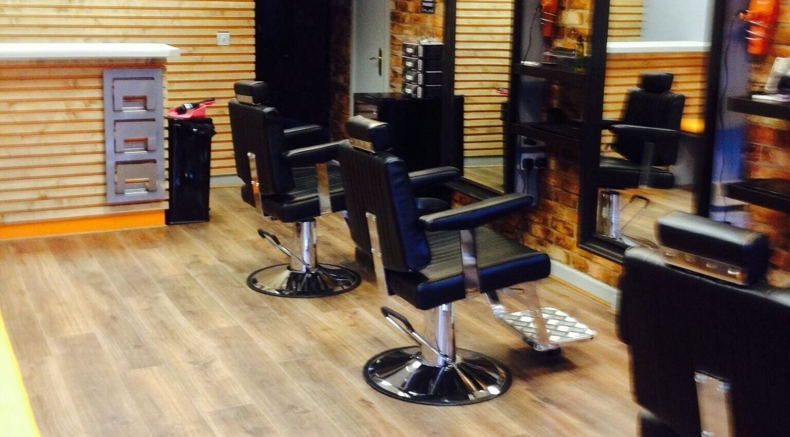 Sleek barber chairs in Ballymena Barber Company, Ballymena, Northern Ireland, GB, showcasing stylish interior.
