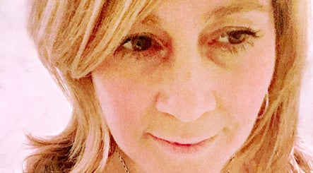 Close-up of a smiling individual at Radiant You, Massage & Coaching in San Anselmo, California, US.