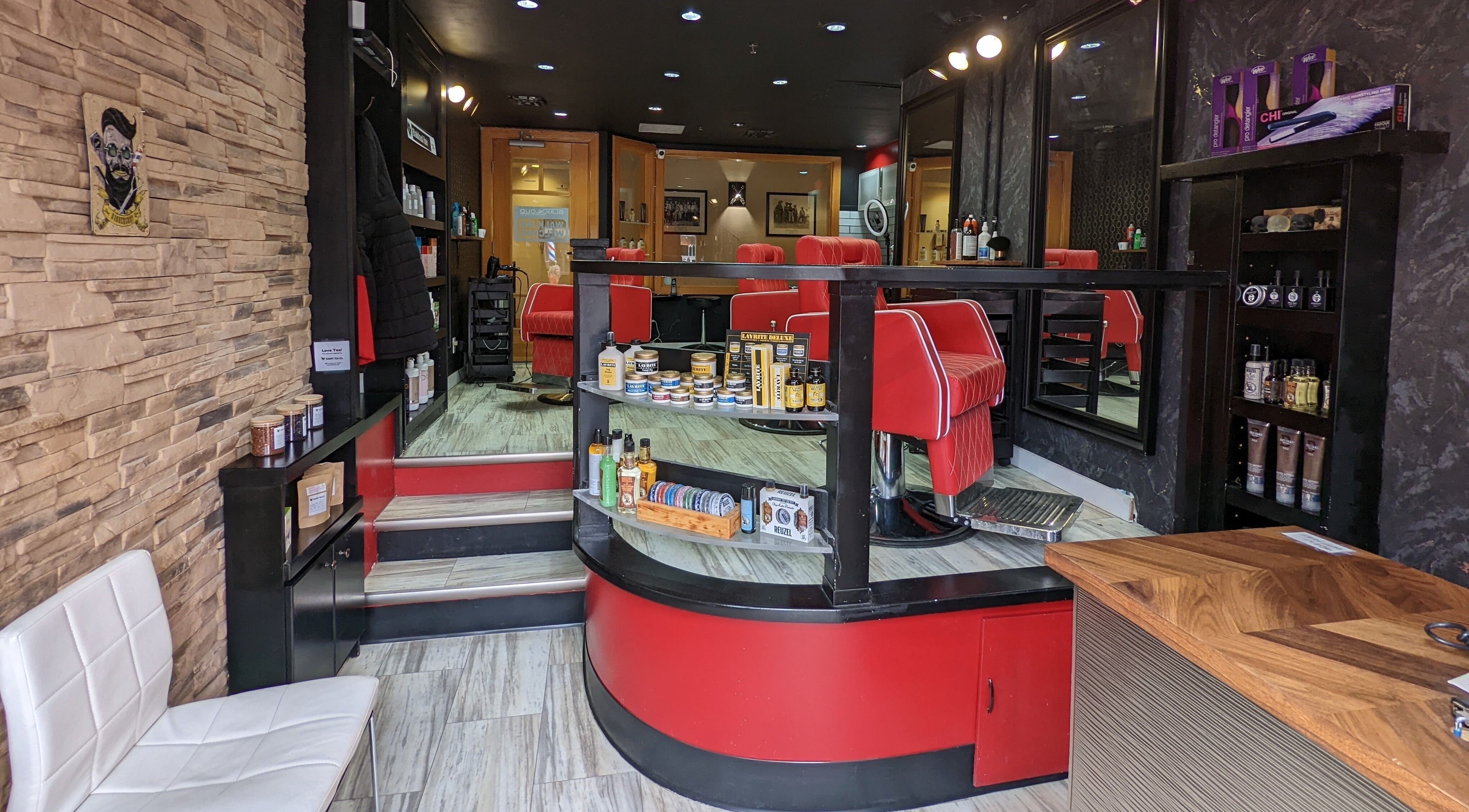 Stylish barber chairs and products at Blakkloud, Banff, Alberta, CA, creating a modern grooming vibe.