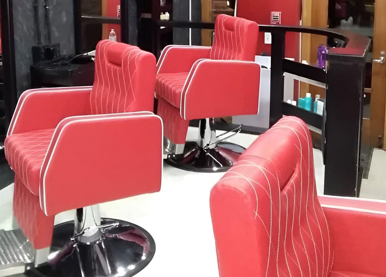 Red salon chairs at Blakkloud beauty salon in Banff, Alberta, CA, offering premium wellness services.
