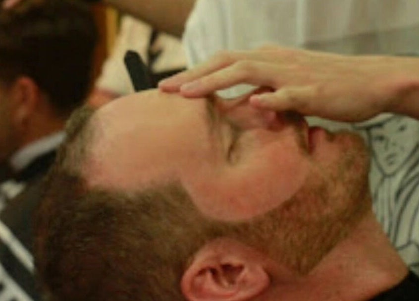 Customer receiving a relaxing haircut at Blakkloud in Banff, Alberta, CA.