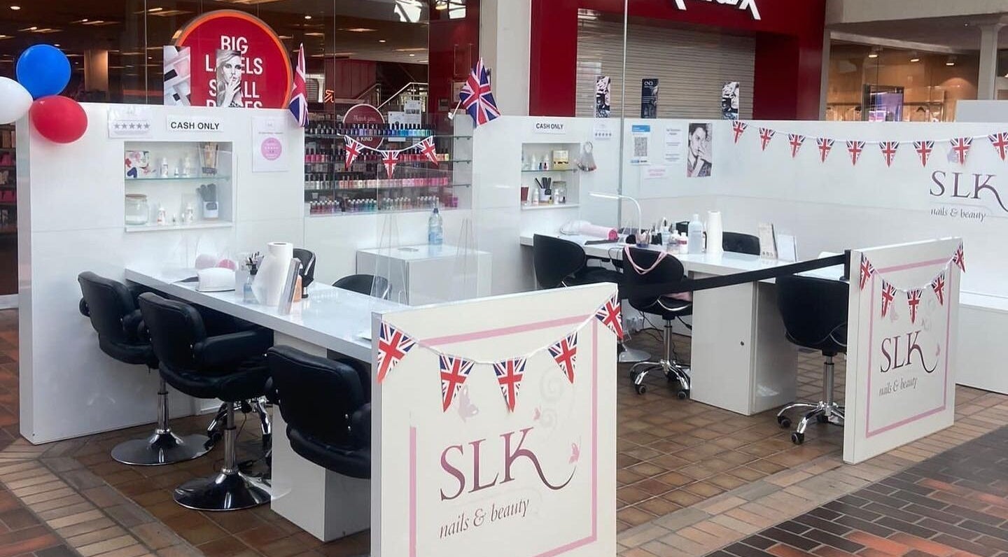 Modern nail stations at SLK Nails and Beauty, Hempstead, England, GB, adorned with festive decor.